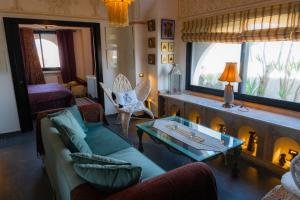 a living room with a couch and a table at Dar Al Makam - Luxury Experience in Soliman