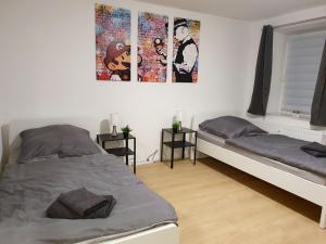 a bedroom with two beds and posters on the wall at Beautiful Apartment in Bad Oldesloe in Bad Oldesloe