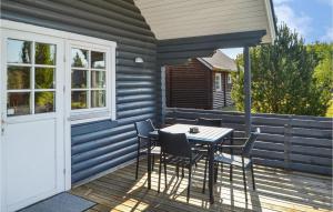 a patio with a table and chairs on a deck at Two-Bedroom Holiday Home In Hovborg in Hovborg