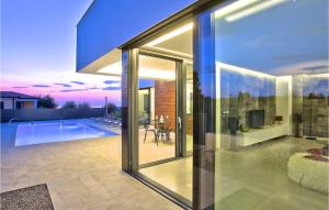 a glass house with a view of a swimming pool at Villa Aria in Poreč