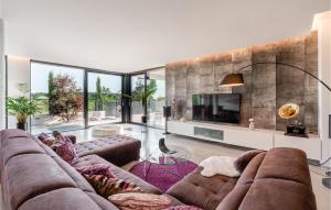 a living room with a large couch and a tv at Villa Aria in Poreč