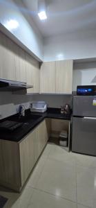 a kitchen with a stove and a counter top at Mabolo Garden Flats Bnb in Cebu City