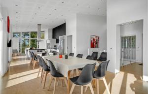 a dining room with a white table and chairs at Nice Home In Ebeltoft With Sauna in Ebeltoft