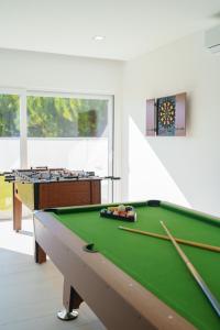 a pool table in a living room with a pool table at Villa Beach and Friends with ocean view in Lourinhã