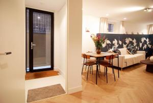 a living room with a table and a couch at Spacious Suite at Park and Museum in Amsterdam