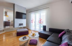 a living room with a couch and a table at Beautiful Home In Pula in Pula