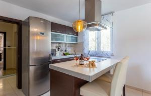 a kitchen with a stainless steel refrigerator and a counter at Beautiful Home In Pula in Pula