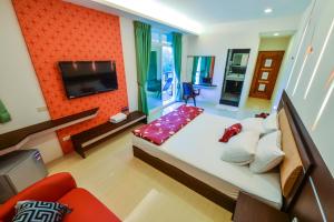 a bedroom with a large bed and a television at 海角203民宿 in Magong