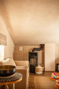 a living room with a couch and a fireplace at Casa dos Pescadores in Carvalhal