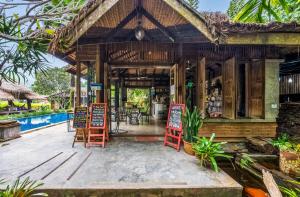 a resort with a restaurant with chairs and a pool at Buzzas @ Pai Chan in Pai