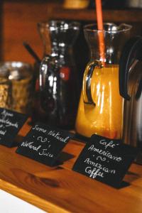 a tray with signs on it with a jug of orange juice at Aldeia da Cuada in Faja Grande