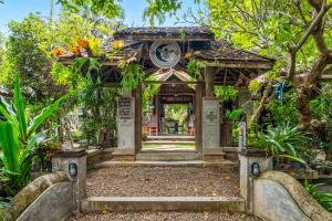 an entrance to a garden with a building at Buzzas @ Pai Chan in Pai