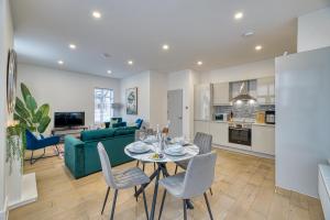 a living room with a table and a green couch at Eden Grove 2 Bed Holiday Retreat With Hot Tub in Kirkby Thore