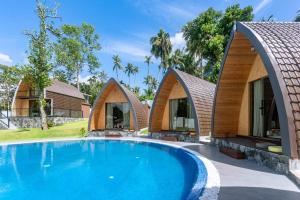 a house with a swimming pool in front of it at Linasi Resort Sri Lanka in Ahangama
