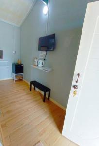 a living room with a tv and a wooden floor at Tamu Chalet Cherating in Kuantan +28 photos
