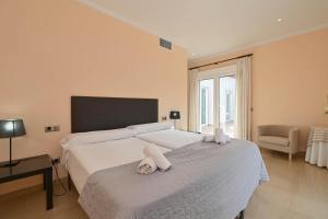 a bedroom with two beds with towels on them at Villa Angels in Teulada +29 photos
