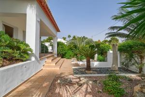 a courtyard of a house with trees and plants at Villa Angels in Teulada