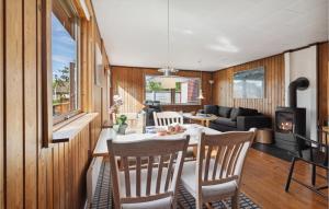 a kitchen and living room with a table and chairs at Holiday Home Rønnemose Sydals Denm in Skovby