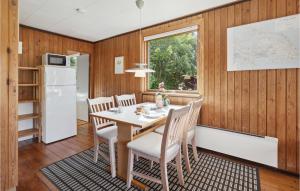 a kitchen and dining room with a table and chairs at Holiday Home Rønnemose Sydals Denm in Skovby