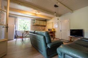 a living room with a couch and a table at Beloesieje gites in Castelsagrat