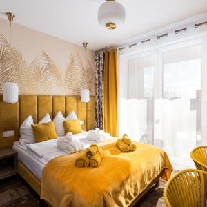 a bedroom with a bed with towels on it at Villa Vis a Vis in Trzęsacz +65 photos