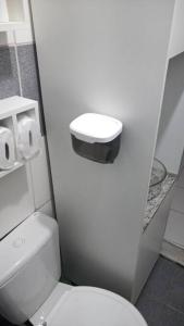 a small bathroom with a white toilet in a stall at Casa Amarela, Ilha dos Frades in Salvador