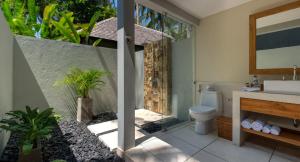 a bathroom with a toilet and a sink at The Chandi Boutique Resort & Spa in Senggigi