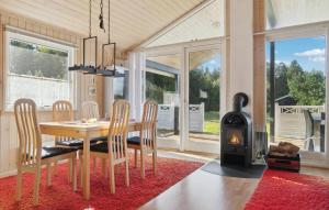 a dining room with a table and a wood stove at 3 Bedroom Gorgeous Home In Ebeltoft in Ebeltoft