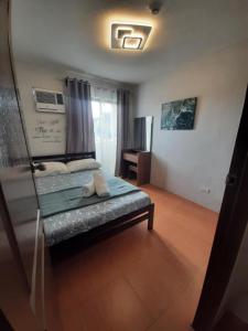 a bedroom with a bed and a mirror in a room at Cagayan de oro One Oasis - 2 Bedroom Unit in Cagayan de Oro