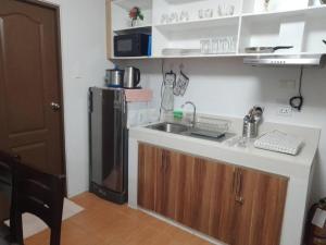 a kitchen with a sink and a refrigerator at Cagayan de oro One Oasis - 2 Bedroom Unit in Cagayan de Oro +11 photos