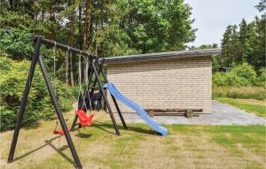 a swing set in a yard with a bench at Four-Bedroom Holiday Home In Ebeltoft in Ebeltoft +21 photos