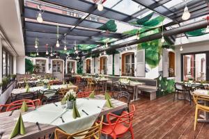 a restaurant with tables and chairs and a mural at Brauereigasthof Püttner in Schlammersdorf