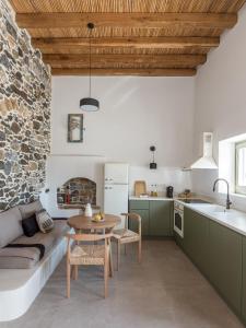 a kitchen and living room with a table and a couch at Saluti Da Stampalia Chora in Pera Gyalos