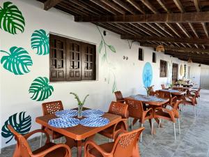 a row of tables and chairs in a restaurant at Pousada Costamar in Maragogi