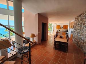 a kitchen and dining room with a table and chairs at Only Adult Villa El Abanico in Almuñécar