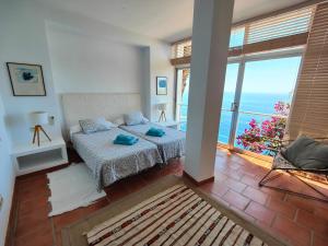 a bedroom with a bed and a view of the ocean at Only Adult Villa El Abanico in Almuñécar +82 photos