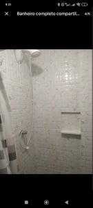 un baño con ducha con cabezal de ducha en Casa Urbana, en Blumenau