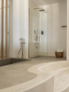 a bathroom with a shower and a tub at Saluti Da Stampalia Chora in Pera Gyalos +23 photos