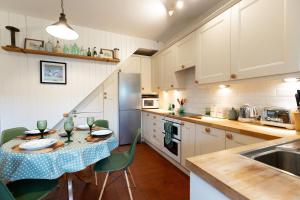 a kitchen with a table with a blue table cloth at DUNELM COTTAGE - Three Bed Cottage in the heart of the Peak District in Edale