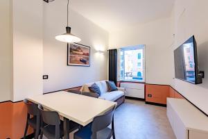 a living room with a table and a couch at JOIVY Bright 2BR flat, moments from the beach in Sestri Levante