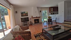 a living room with a table and a fireplace at VILLAS COSETTE Villa Cami de les Penyes in GRO