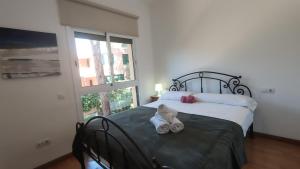 a bedroom with a teddy bear sitting on a bed at VILLAS COSETTE Villa Cami de les Penyes in GRO +14 photos