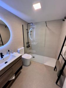 a bathroom with a sink and a toilet and a shower at Villa de Béjar in Béjar