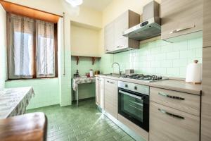 a kitchen with a stove and a sink at Appartamento Casa Rita - Sorano in San Giovanni delle Contee