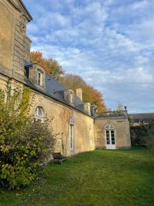 an old building with a grass yard next to it at Our House, Château de la Boulaye in Cerisy-la-Forêt +55 photos