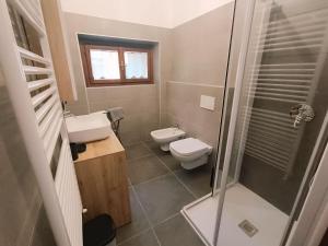 a bathroom with a toilet and a sink and a shower at Casa del Cerbiatto, Lake Como a 5 chilometri da Argegno in Castiglione dʼIntelvi +24 photos
