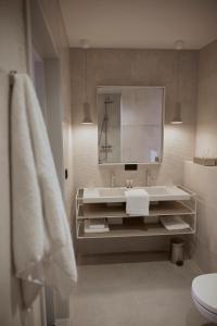 a bathroom with a sink and a mirror at Hotel Oostergoo in Grou +23 photos