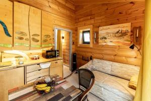 a bedroom with a bed in a wooden cabin at Blockhaus am Baumwipfelpfad in Neuschönau