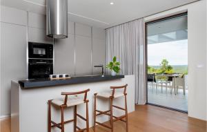 a kitchen with a counter and two stools at Villa Adoral in Labin +20 photos