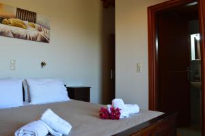 a bedroom with a bed with towels on it at George Stone Villa in Andipáta Erísou +41 photos